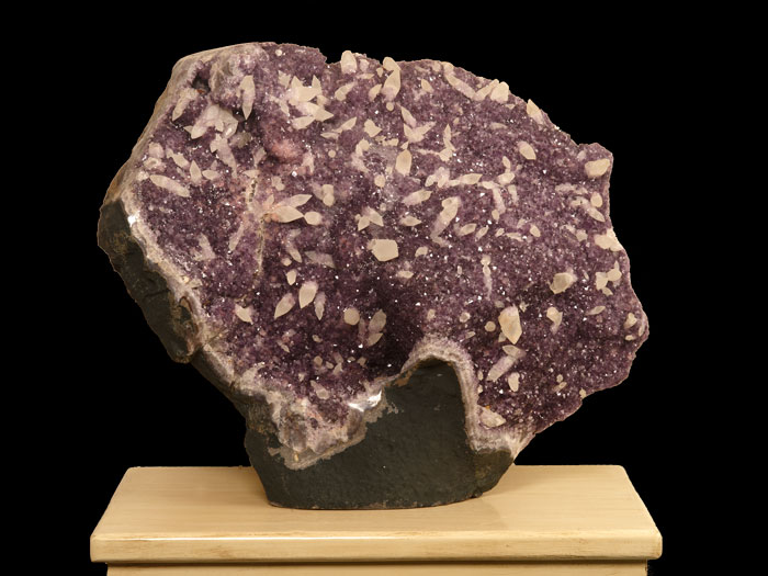 Large Brazilian amethyst geode with calcite crystals